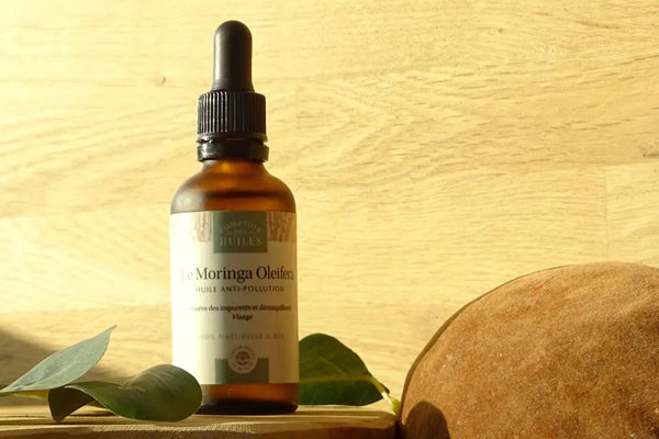 flacon de moringa oleifera avec feuilles et une coque de fruit du baobab
